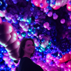 Katrina smiling in a room full of balloons