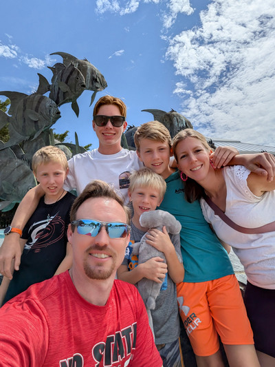 A team member's family posing outside a park.