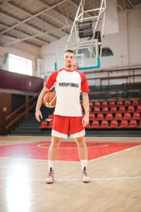basketball-player-standing-on-basketball-court-3764203-200x300.jpg