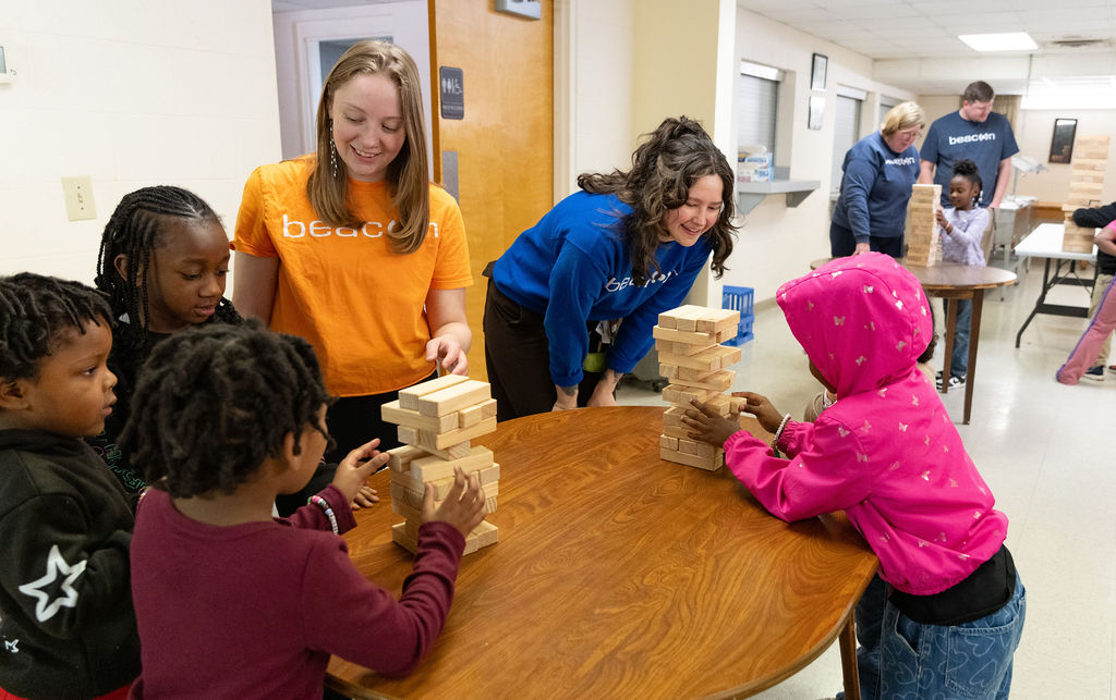Beacon team members playing Jenga with students at BCDI
