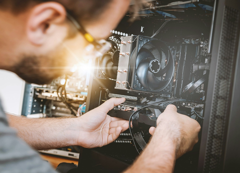 man working on a piece of computer hardware