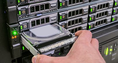 woman reMoving a hard drive from data center