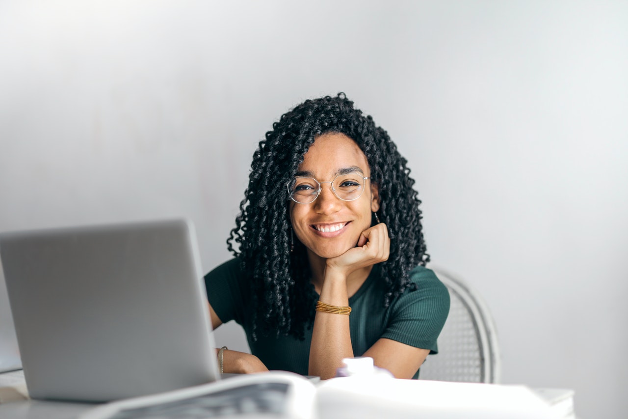 smiling student at a laptop