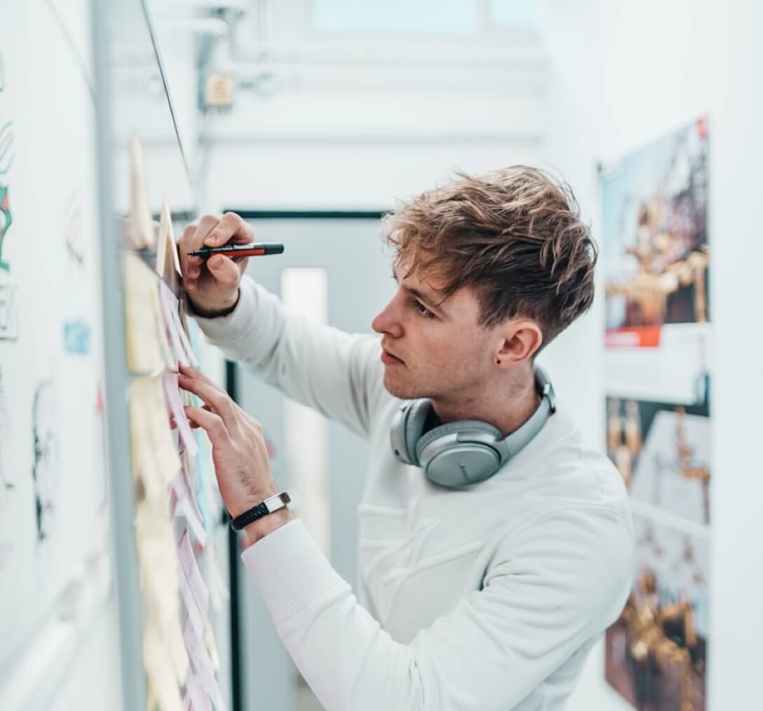 student writing on a sticky note