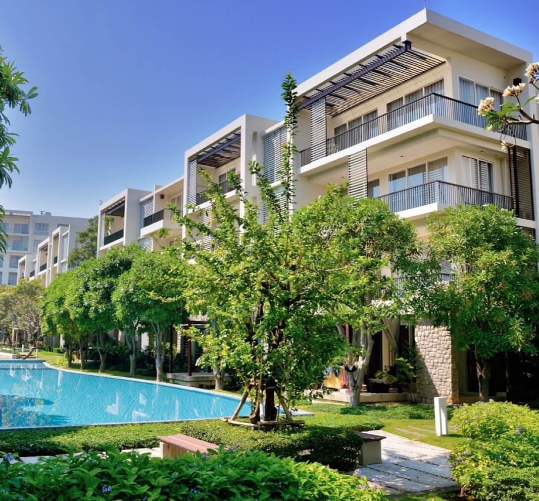pool and trees near apartment buildings